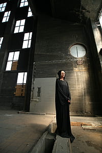 Standing Woman Wearing Black Long-sleeved Dress thumbnail