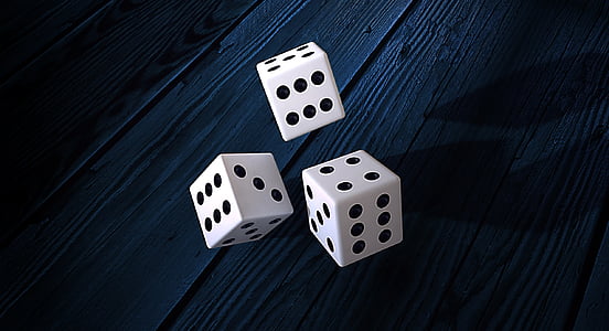 three dice on wooden tables thumbnail