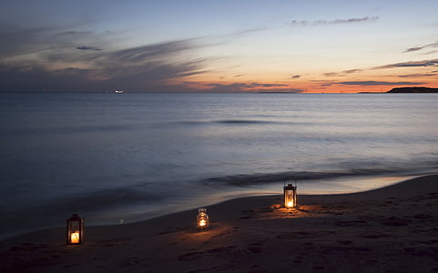 three beige lamps on brown sand thumbnail