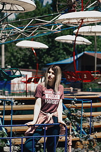 Woman Standing Beside Brown Bench thumbnail