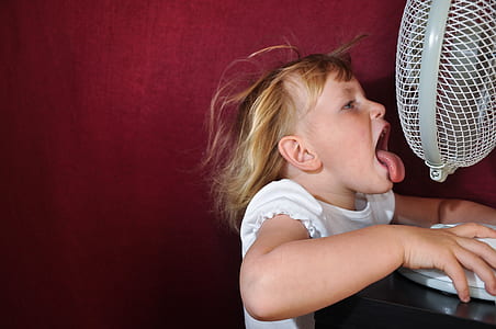photo of girl near white desk fan thumbnail