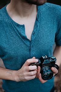 person holding black DSLR camera thumbnail
