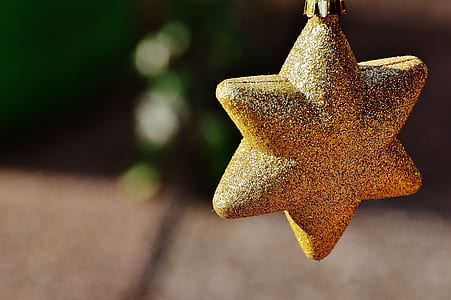 selective focus photography of gold star ornament with glitter thumbnail