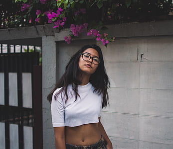 woman wearing white crew-neck crop-top near wall thumbnail