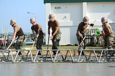 soldier holding rake near building thumbnail