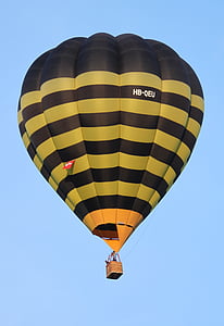 people riding on yellow and black hot air balloon thumbnail