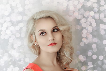 woman standing on front of bokeh effect wall thumbnail