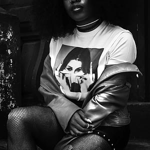 grayscale photo of woman wearing white graphic crew-neck shirt thumbnail