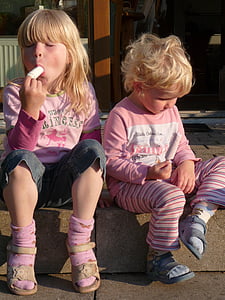 two girls sitting near stall thumbnail