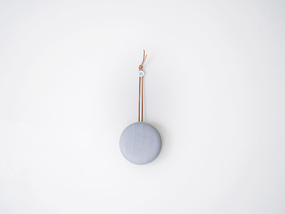 round gray fabric hanging decor on the wall thumbnail