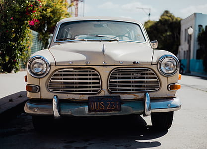 classic white Volvo vehicle parked at road near building at daytime thumbnail