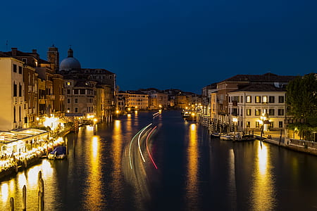 time-lapse photography of buildings and body of water during night thumbnail