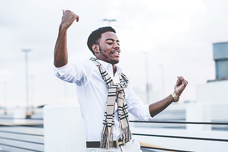 man raising both of his hands near fence thumbnail