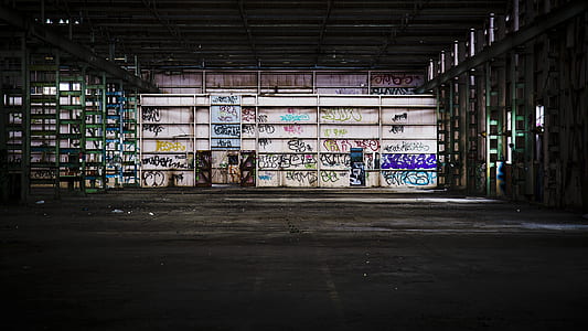 gray metal shelving unit empty with graffiti thumbnail