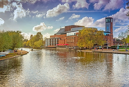 photography of brown concrete building beside river during daytime thumbnail