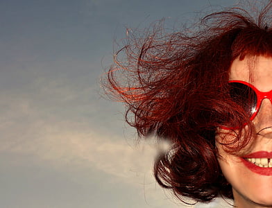 woman wearing red-framed sunglasses smiling thumbnail