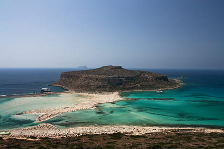 green and white island surrounded by blue and green water during daytime thumbnail