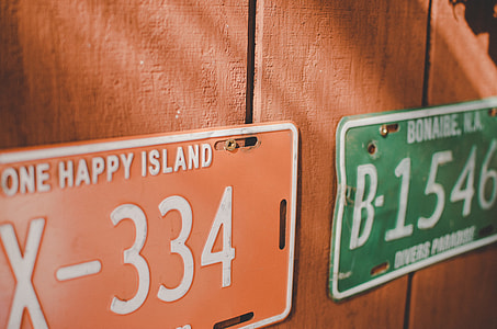 orange and green license plate mounted on wall thumbnail