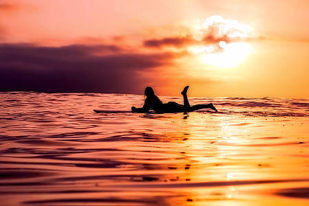 silhouette of person of surfboard on sea thumbnail