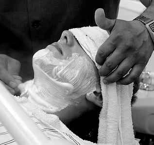 grayscale photo of person with white cream thumbnail