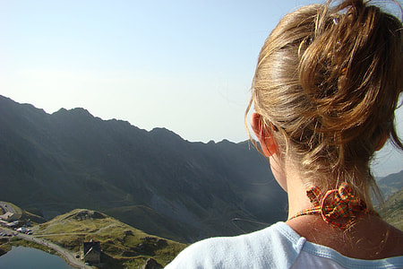 photo of woman facing green mountain during daytime thumbnail