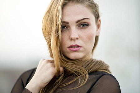 selective focus photography of woman wearing black mesh top thumbnail