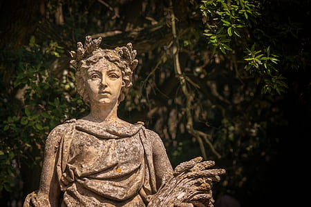 selective focus photography of woman statue near trees thumbnail
