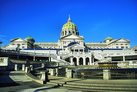 white concrete building with dome under blue sky at daytime thumbnail