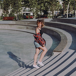 Photo of Woman in Black Tank Top Walking on Stairs at a Park thumbnail