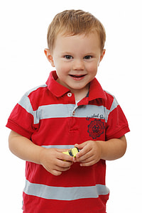 boy in red and white striped polo shirt holding yellow toy car thumbnail