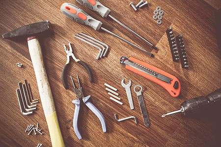 assorted handheld tools on wooden parquet thumbnail