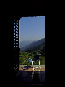 Blue and White Empty Armchair during Daytime Outside With Mountain Range Under Blue Sky during Daytime thumbnail