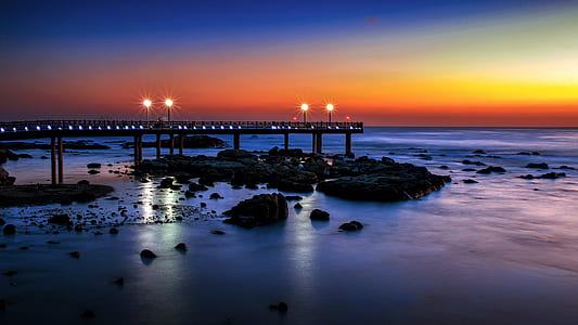 dock and rock formation during sunset thumbnail