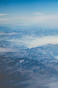 blue and gray mountain under blue and white skies at daytime thumbnail