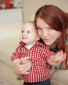 woman holding toddler standing on seat thumbnail