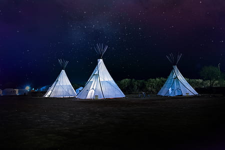 three white tipi tent during nighttime thumbnail