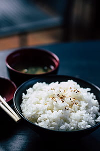 round black ceramic bowl with white rice thumbnail