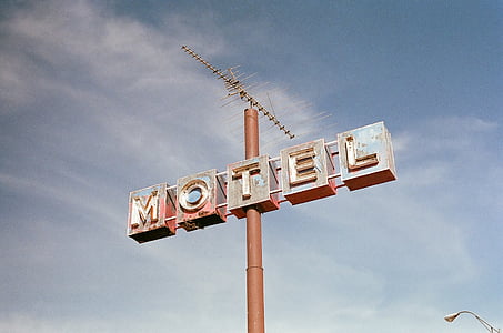 white Motel signage under cloudy sky during daytime thumbnail