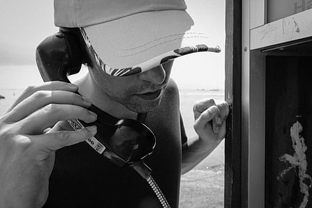 grayscale photography of man holding telephone thumbnail