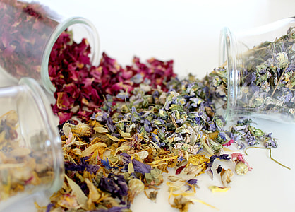 three tipped over clear vases with dried flowers on white surface thumbnail