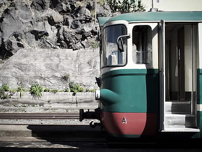 teal and white train on railroad thumbnail