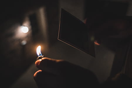person holding lighted disposable lighter thumbnail
