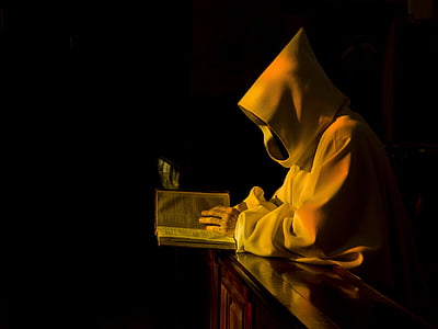 person wearing white robe leaning on clear glass table thumbnail