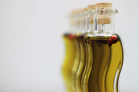 shallow focus photography of clear glass bottle with yellow liquid inside thumbnail