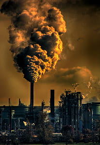 factory smoke under cloudy sky during daytime thumbnail