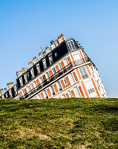 landscape photography of beige and black concrete building under clear blue sky during daytime thumbnail