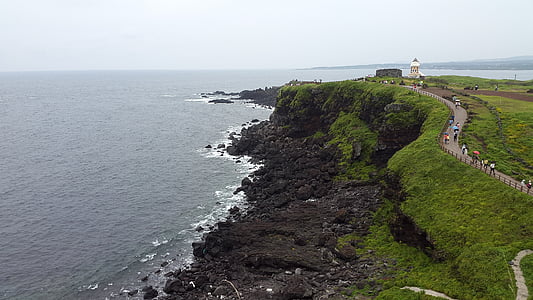 high angle photography of cliff near beach thumbnail