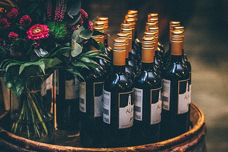 unopened bottles on brown wooden side table thumbnail