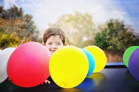 boy near assorted-color balloons thumbnail