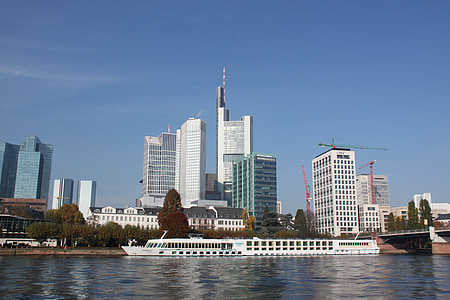 white luxury boat near high-rise buildings thumbnail